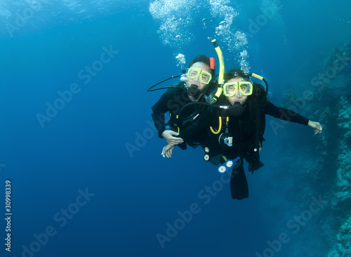 happy couple scuba dive together