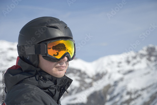 The man in the mountain-skiing form against mountains © Vladimirs Koskins