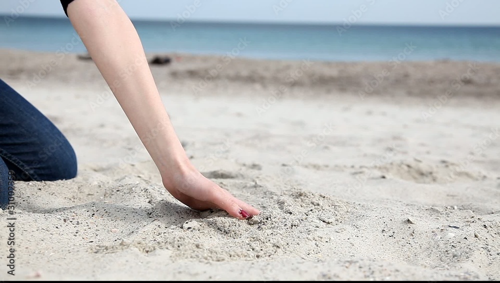 Female move hand over sand Female move hand over sand