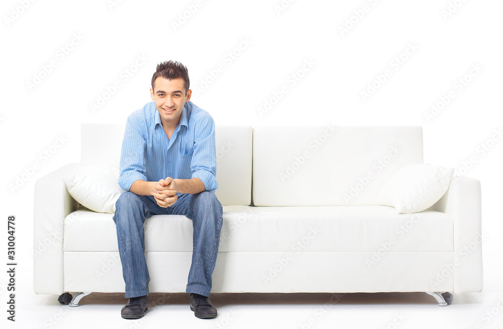 Portrait of the young man in white on sofa