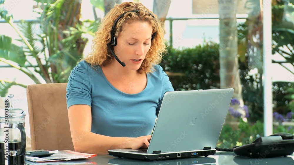 Curly haired woman speaking over the headset Curly haired woman speaking over the headset