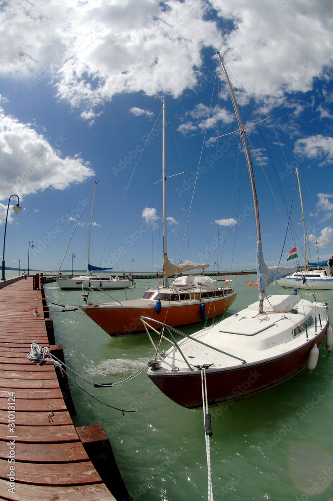 pier with several sports yachts