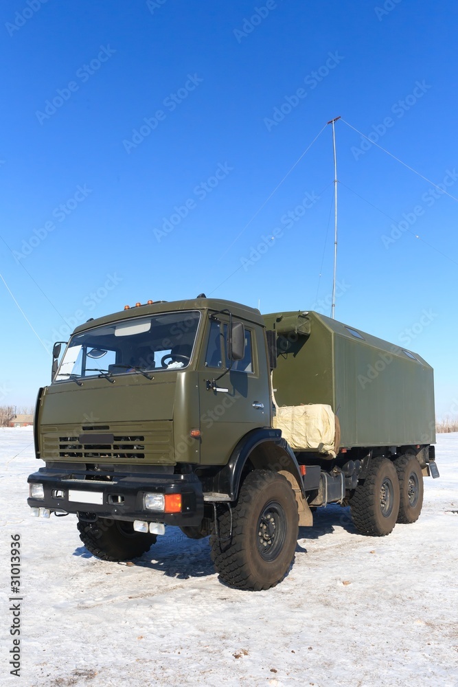 Khaky heavy resque military truck,car on blue sky whith antenne