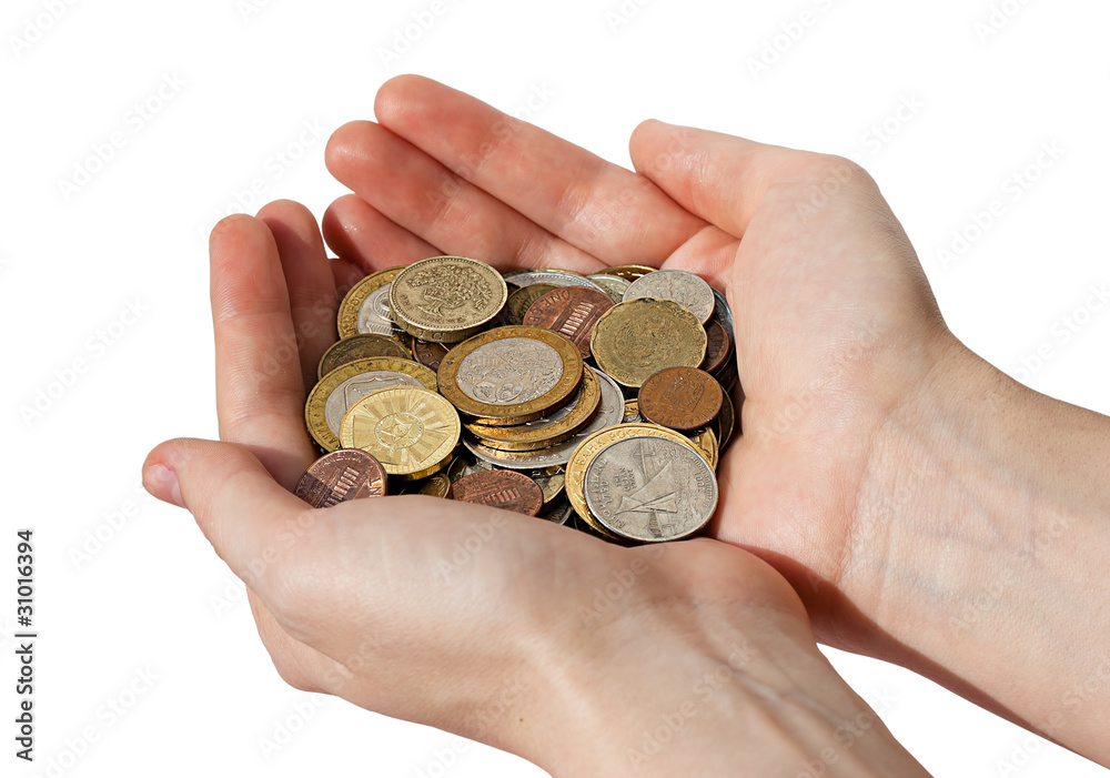 woman's hands holding a pile of different coins woman's hands holding a pile of different coins