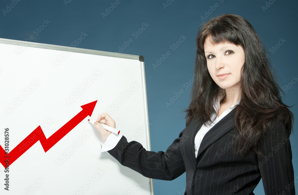 Young businesswoman drawing graph on a board Young businesswoman drawing graph on a board