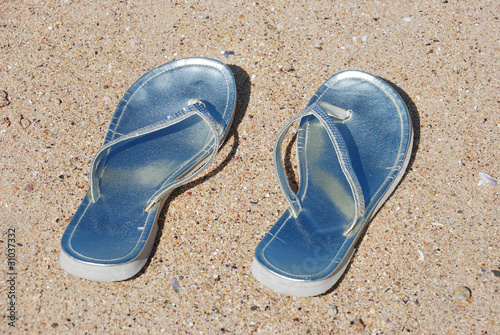woman flip-flops left on the beach