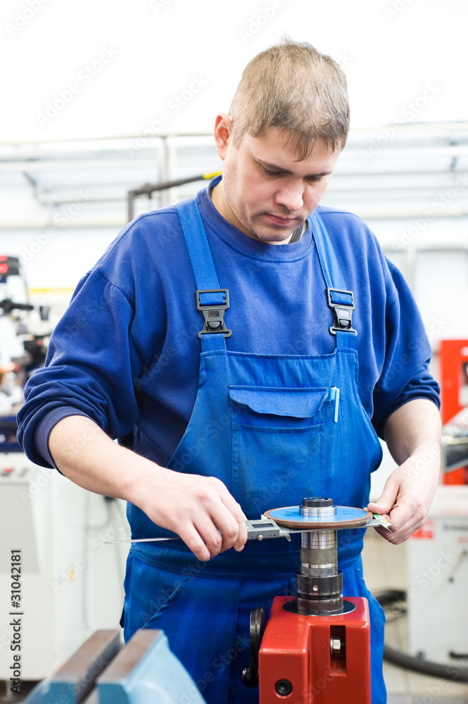 worker checking cutting tool worker checking cutting tool