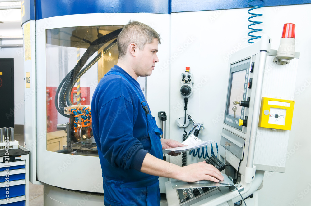 Obraz premium worker operating CNC machine center