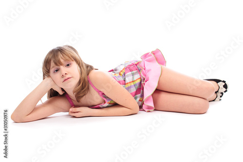 Fotografie Little girl lying down, isolated on white