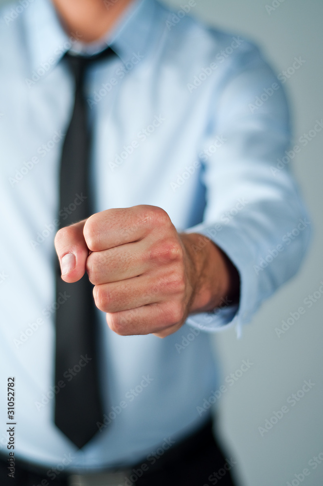 Fototapeta premium Young business man showing strong gesture
