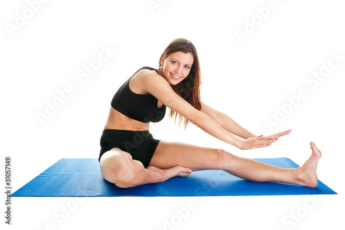 Fitness woman stretching on gym mat