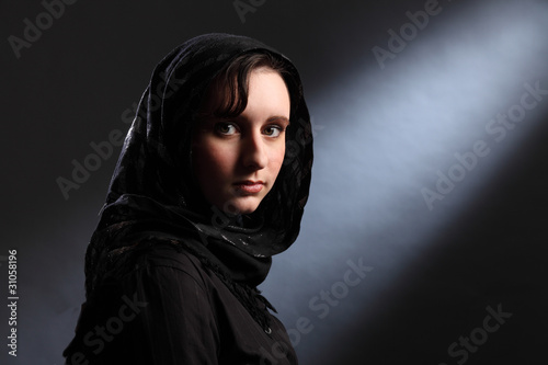 Young muslim woman in hijab has quiet moment