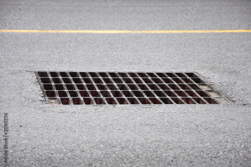 фотографія Drain grating on street