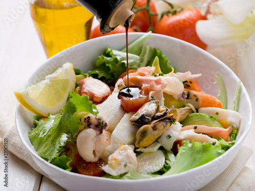 balsamic vinegar over mixed seafood salad photo