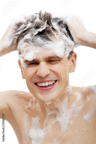 Naked man with shampoo over hair in shower isolated