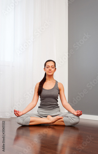 woman doing yoga in room