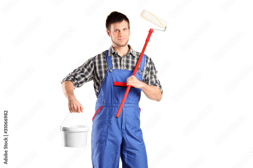 Smiling worker man holding a paint roller and bucket Smiling worker man holding a paint roller and bucket