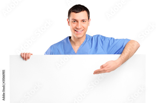 Young medical doctor showing on a blank panel