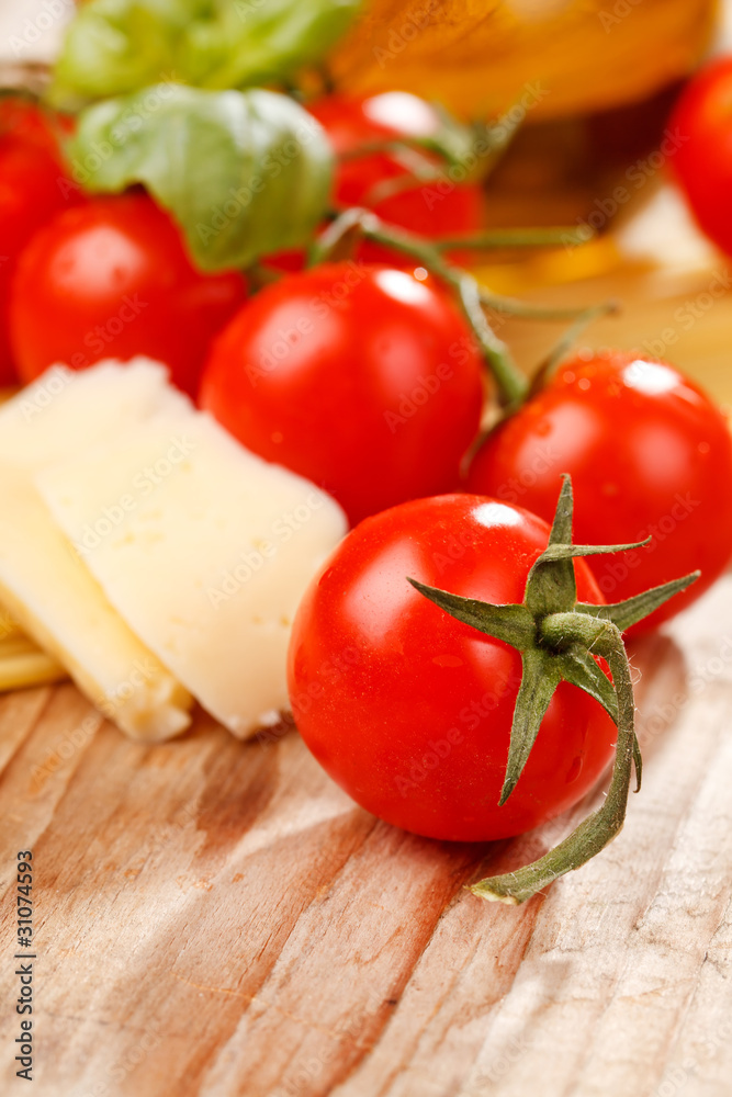 pasta, olive oil and tomatoes on the wood background pasta, olive oil and tomatoes on the wood background