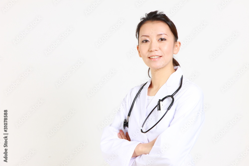 young Japanese female doctor smiles with Folding arms young Japanese female doctor smiles with Folding arms