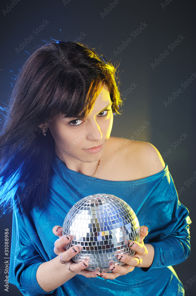 Naklejka premium Portrait of young woman with disco ball