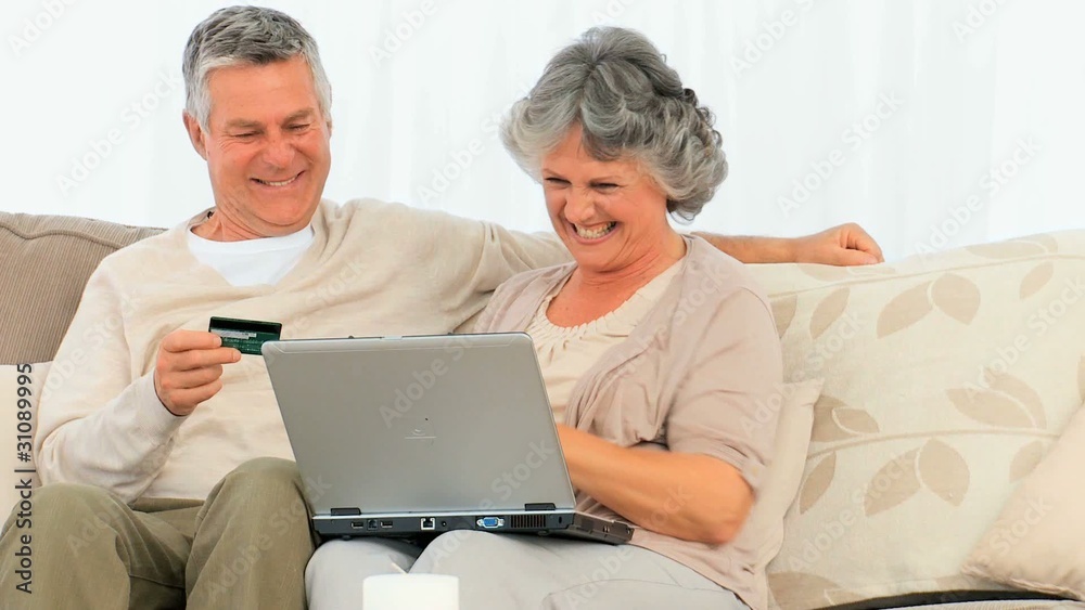 Happy couple buying on the net Happy couple buying on the net