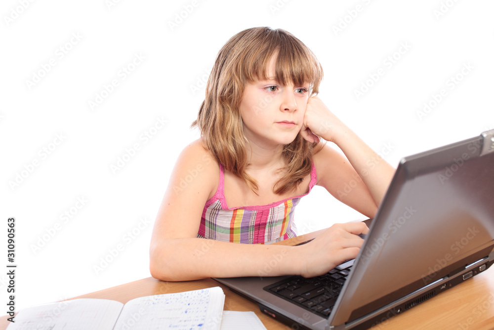 Schoolgirl doing homework at her laptop Schoolgirl doing homework at her laptop