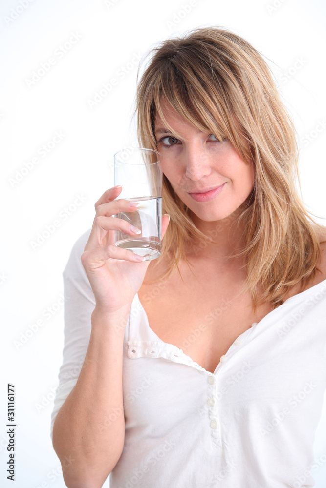Beautiful blond woman holding glass of water Beautiful blond woman holding glass of water