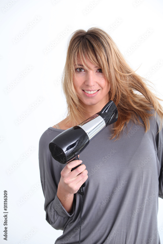 Beautiful woman with hairdryer on white background Beautiful woman with hairdryer on white background