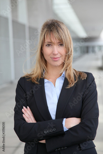 Businesswoman standing outside with arms crossed