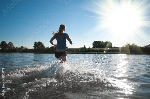 Sport woman running in water