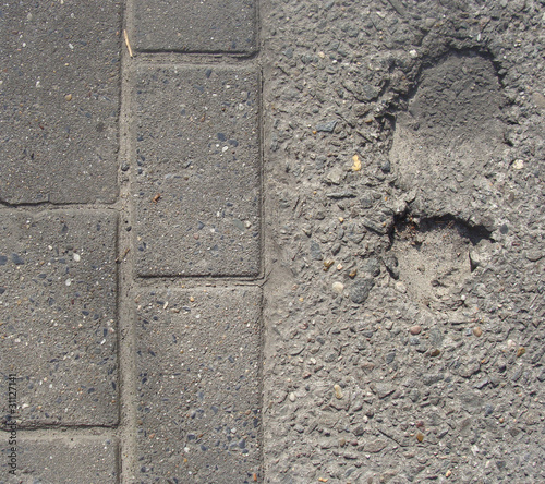 sidewalk with foot-step embedded in concrete