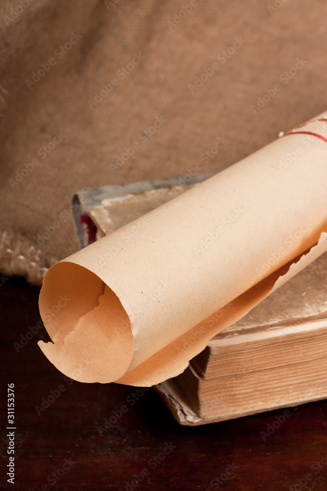 Fototapeta premium Old paper scroll and vintage book