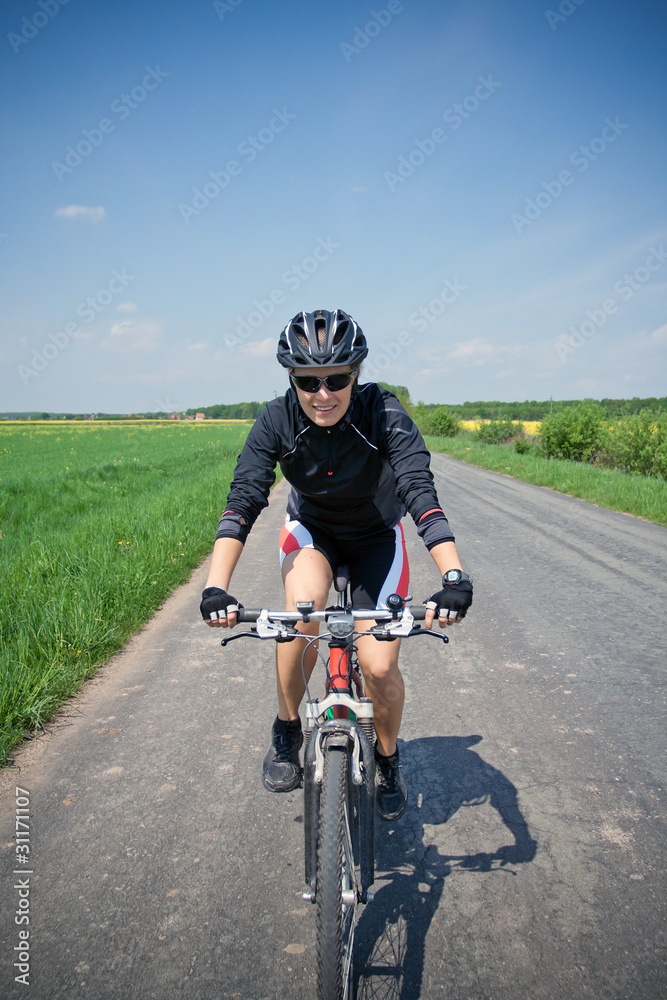 Woman riding bike on a summer day