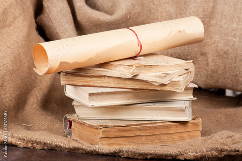 Vintage paper scroll and aged books