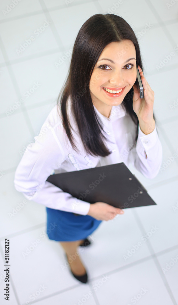 The beautiful business woman talks on the phone The beautiful business woman talks on the phone
