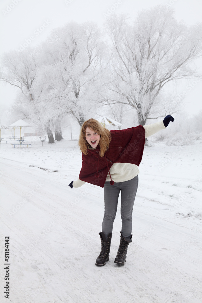 Winter scene, young girl laughing and making fun