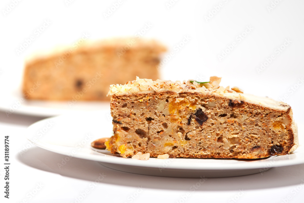 Carrot cake with almonds on a white plate Carrot cake with almonds on a white plate