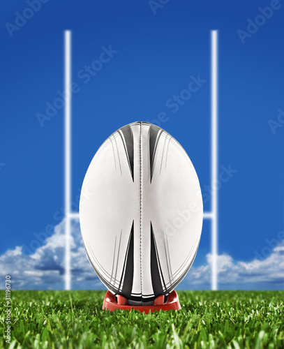 Rugby ball on field with goal posts