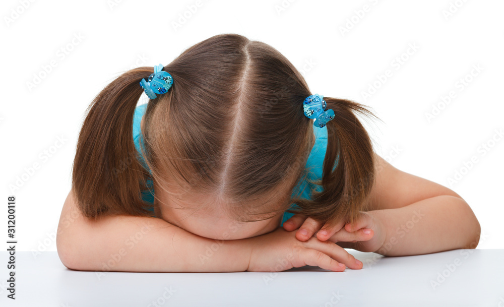 Fototapeta premium Little girl is sleeping at table