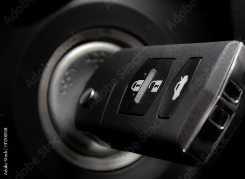 Car key into ignition lock.