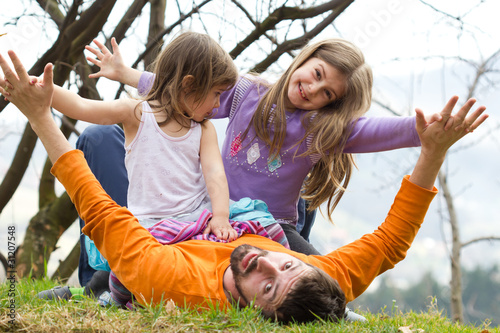 Father playing with his daughters in the park