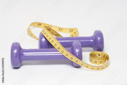 weights and measuring tape on white background