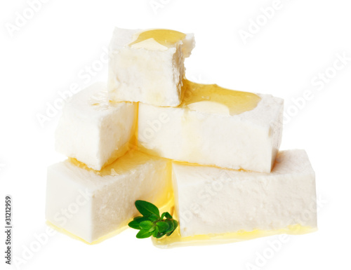 Feta cheese cubes with thyme twig and oil drops