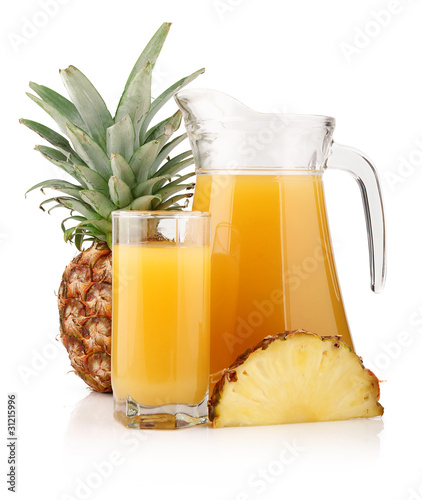 Jug and glass of pineapple juice with fruits isolated