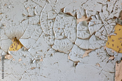 Close up of peeling paint on old plaster wall