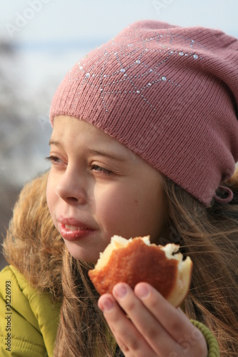 Girl holding bite off doughnut photo