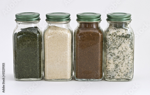 Set of Four Spices in Glass Jars with White Background