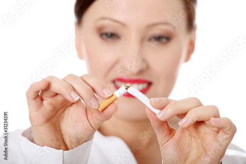Mature woman breaking cigarette