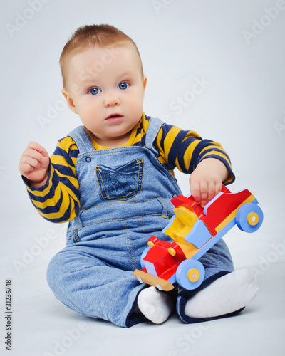 baby boy plaing his toy car photo